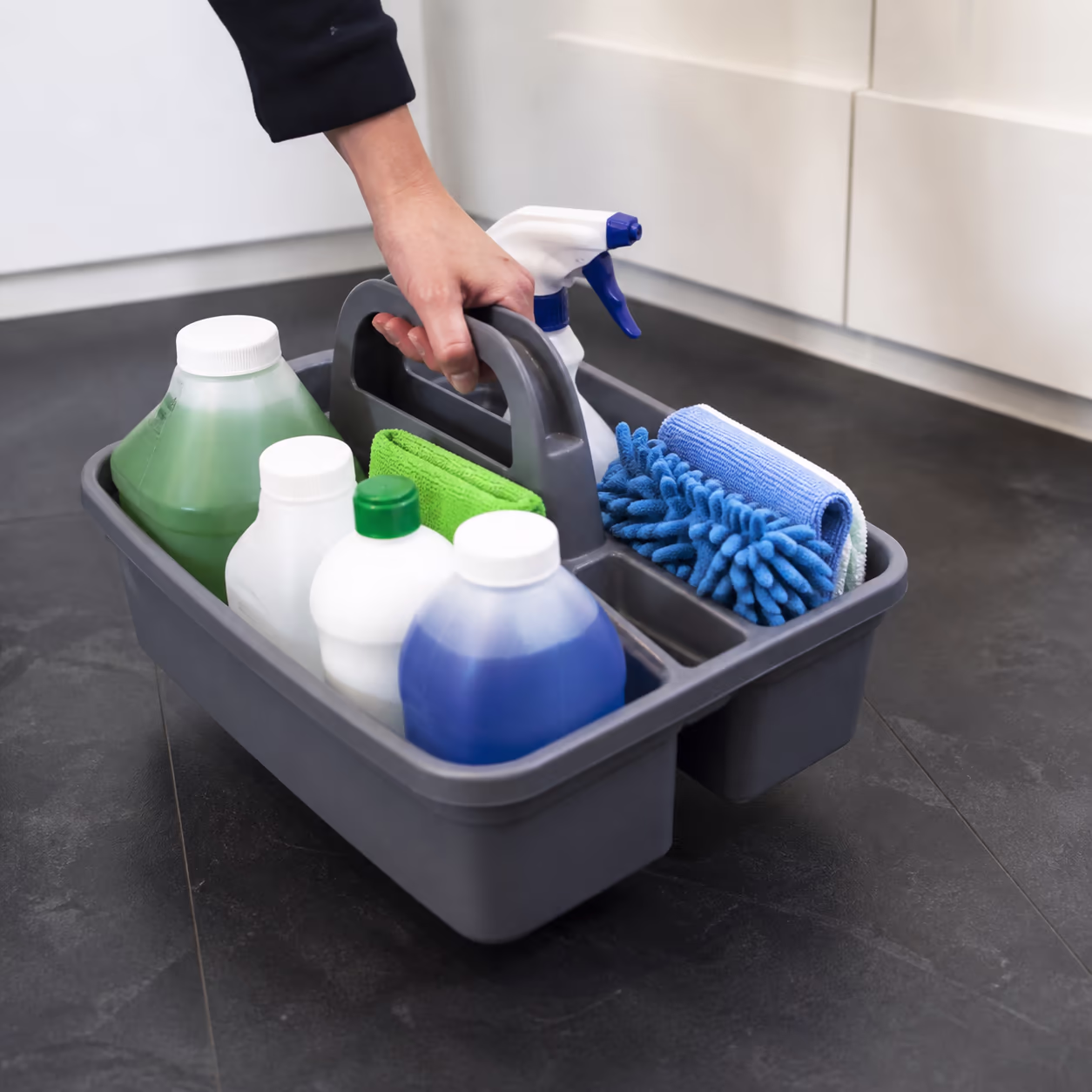 A facility supply shelf stocked with colour-coded commercial cleaning concentrates and microfibre loops in an Ottawa janitorial closet.
