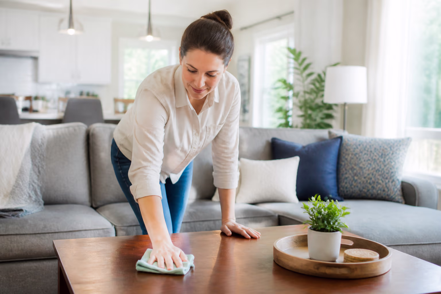 A bright, freshly cleaned living room in an Ottawa home with dusted surfaces, a cleared coffee table and soft daylight, capturing the calm, healthy space that a consistent cleaning routine creates for the whole household.