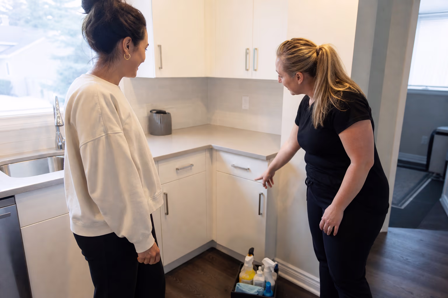 Cleaner and household reviewing a cleaning scope together at a table