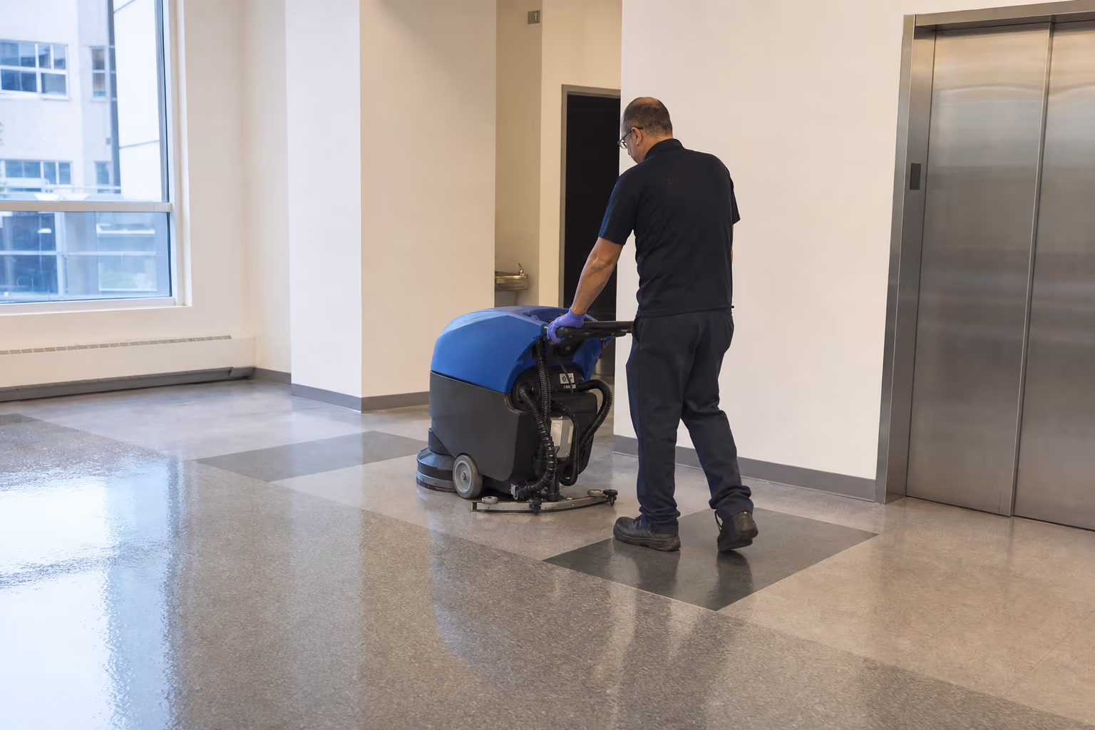 Floor scrubber operator working a resilient floor
