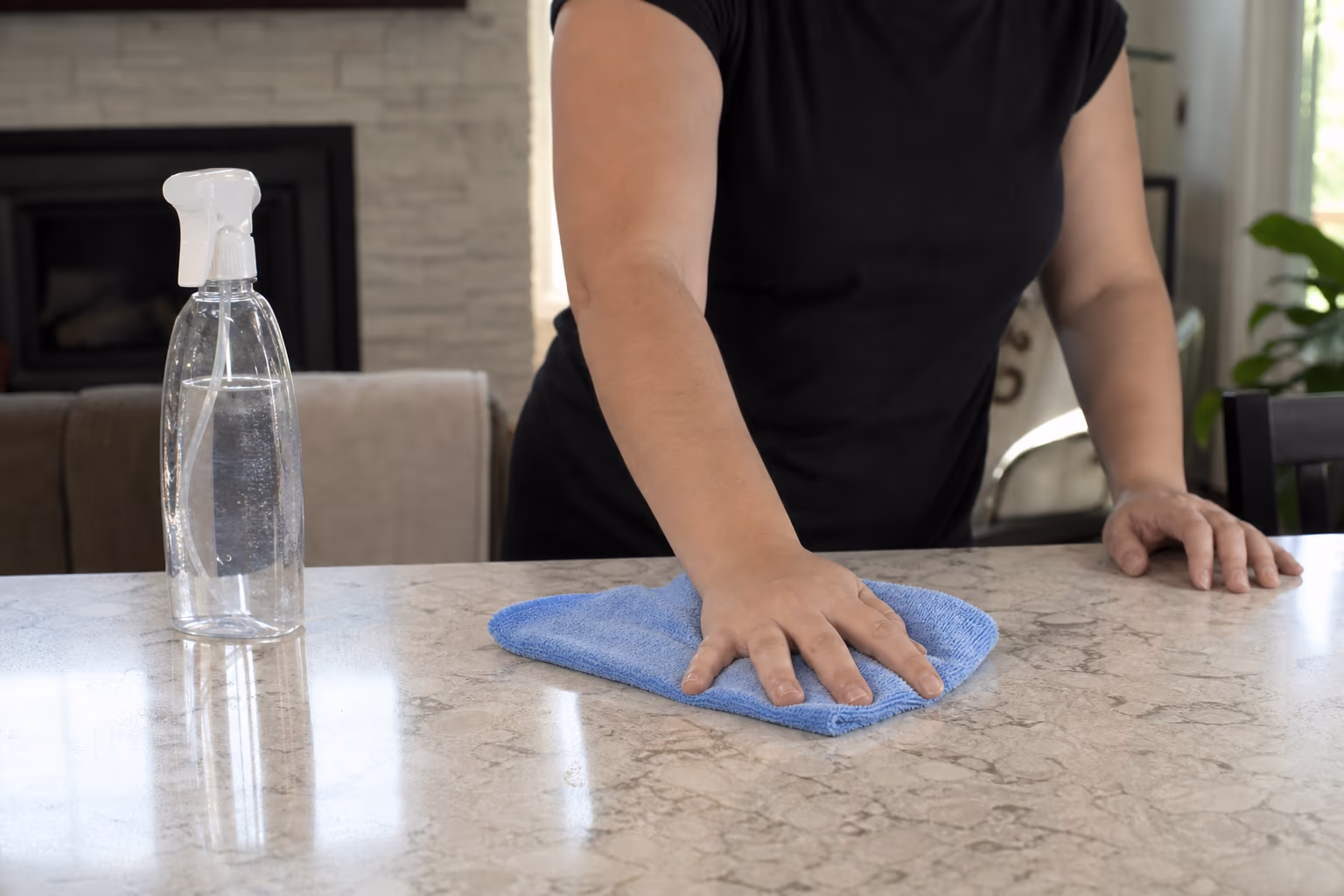 Professional spray bottle and microfiber cloth on a clean surface