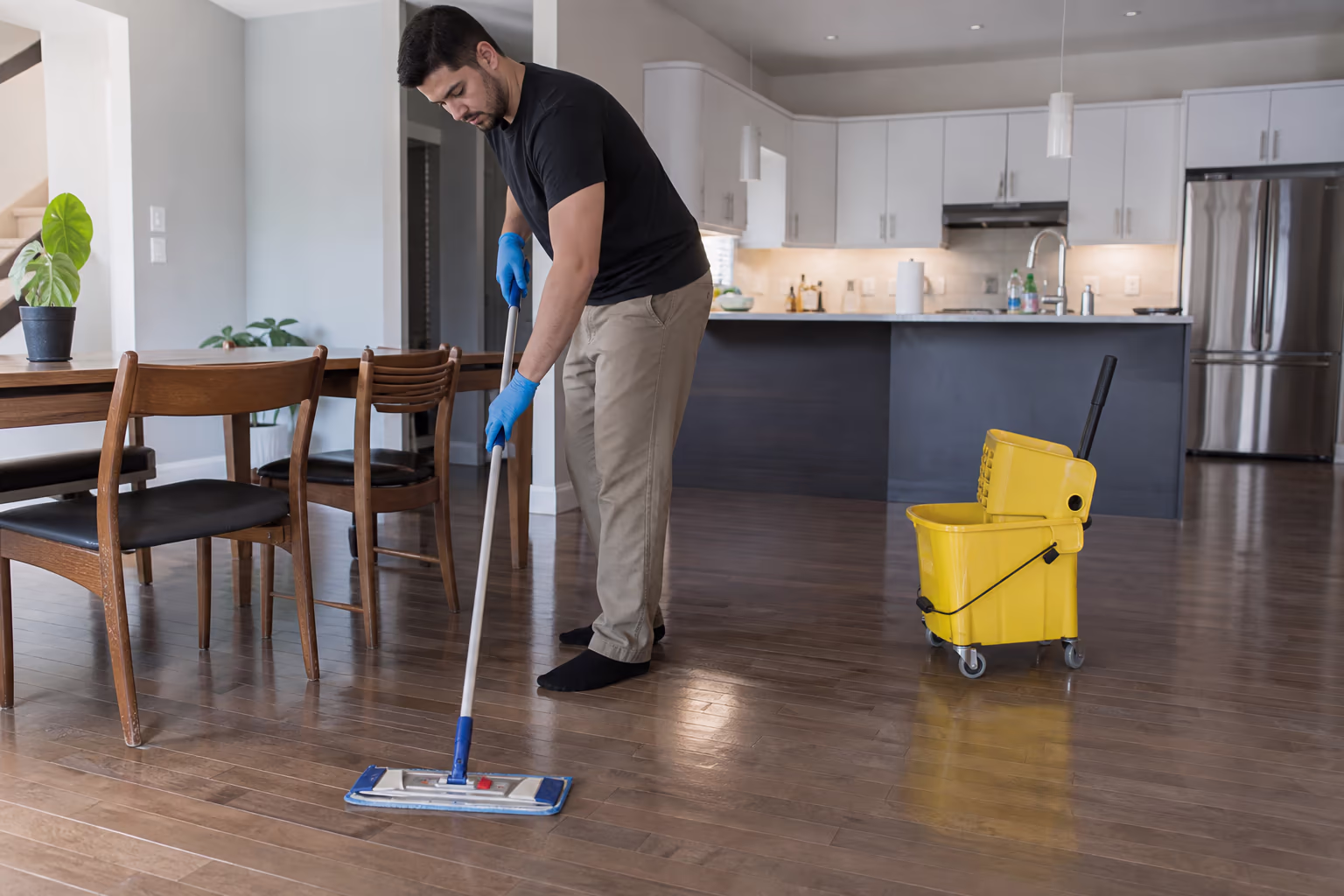 Mop and wheeled bucket on a polished floor