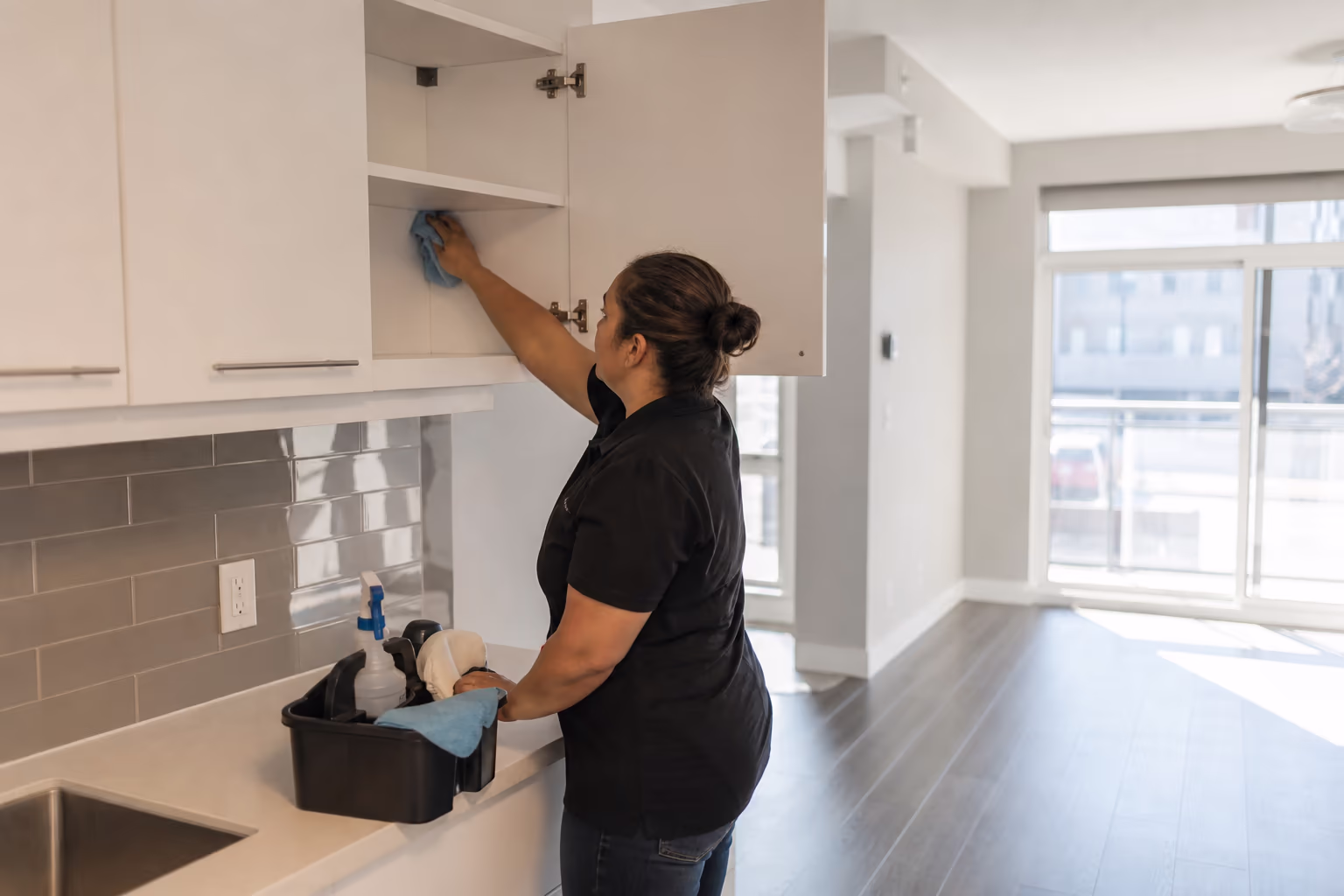 Cleaner preparing an empty kitchen for a move-out cleaning